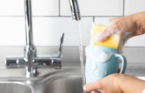 Woman is washing coffee cup.